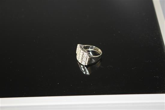 A white metal (stamped 750 and Pt 950) and pave diamond set cocktail ring, of curved design and set with twenty round cut stones.